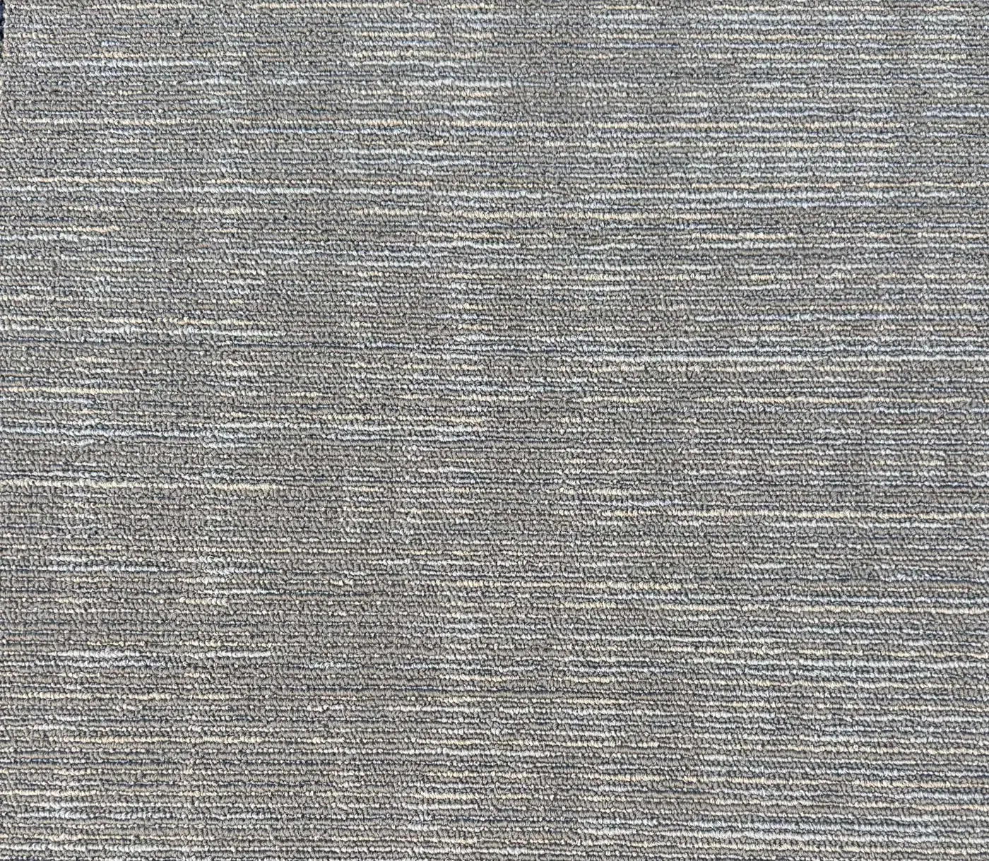 Reclaimed grey carpet tiles laid on a floor
